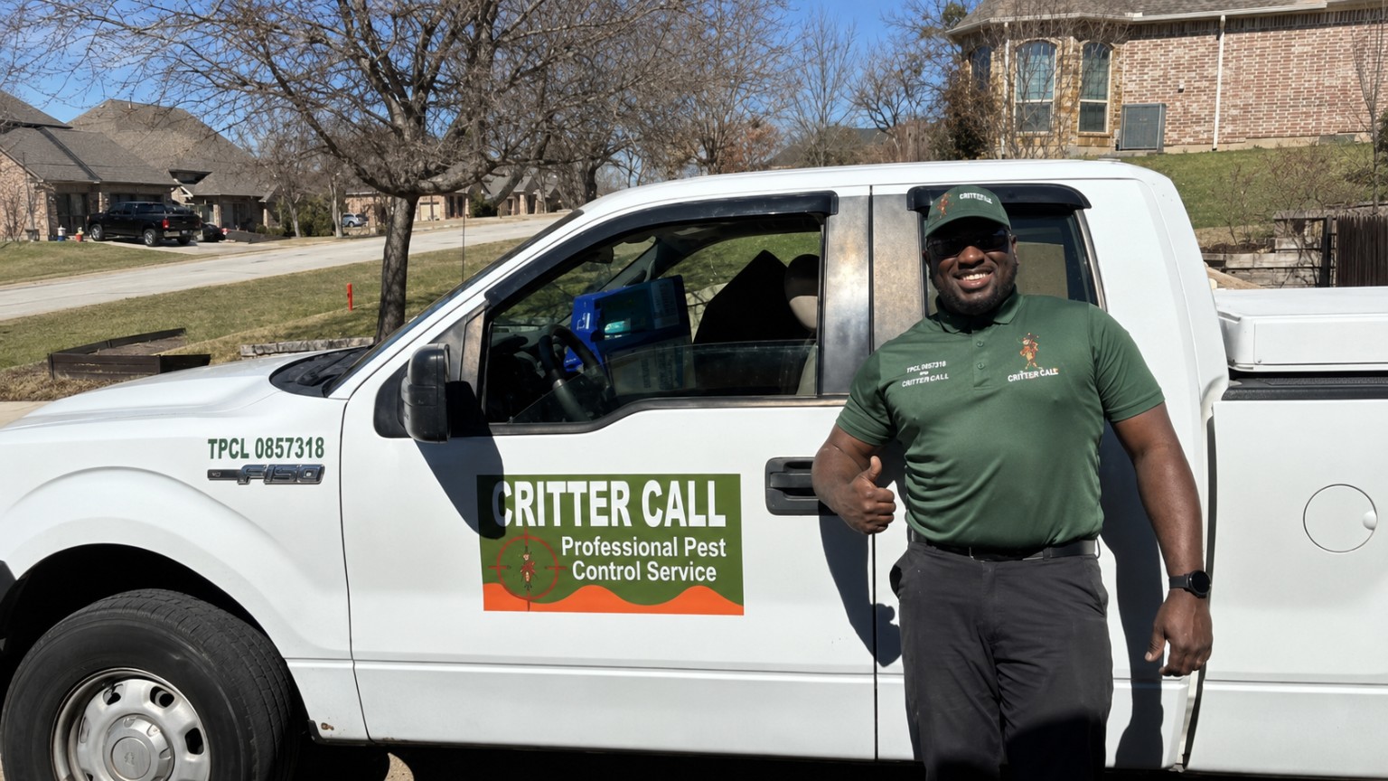 Critter Call technician with a branded Critter Call service truck in a Dallas-Fort Worth neighborhood